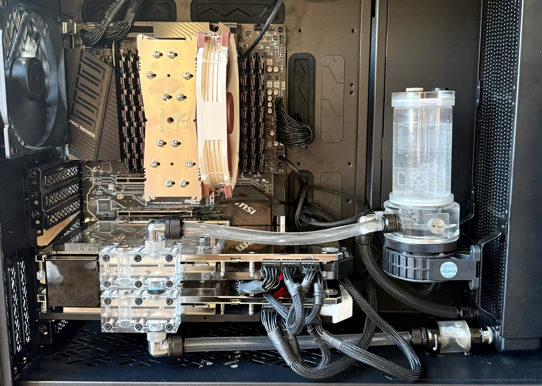 Inside of the workstation case: dual 3090s, one watercooled with a reservoir, one air-cooled, in a Fractal case.